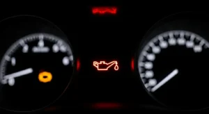 Car dashboard showing engine oil warning light symbol illuminated