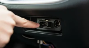 Location of OBD2 diagnostic port under car dashboard