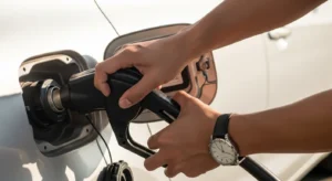 Person tightening gas cap which can cause check engine light