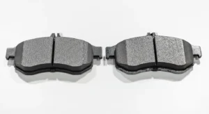 Comparison between new and worn brake pads showing thickness difference