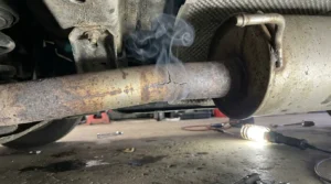 visible exhaust leak smoke under car exhaust system